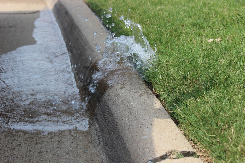 Water,spilling,from,a,broken,sprinkler,head